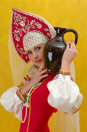 simsearch:400-05051542,k - Close-up. Woman in a folk russian dress holds a jug on yellow background Stock Photo - Budget Royalty-Free & Subscription, Code: 400-04012471