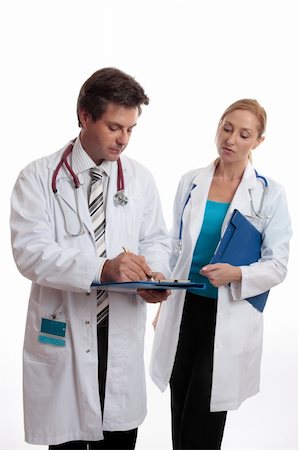 Two doctors discuss a patients medical ailment or treatment. Photographie de stock - Aubaine LD & Abonnement, Code: 400-04012617