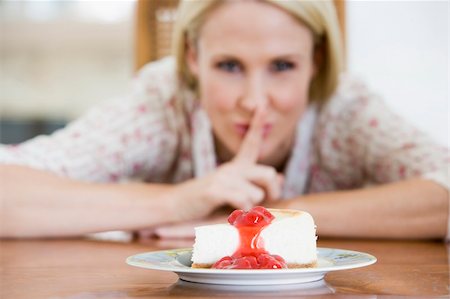 Woman Tempted By Slice Of Strawberry Cheesecake Stock Photo - Budget Royalty-Free & Subscription, Code: 400-04012855