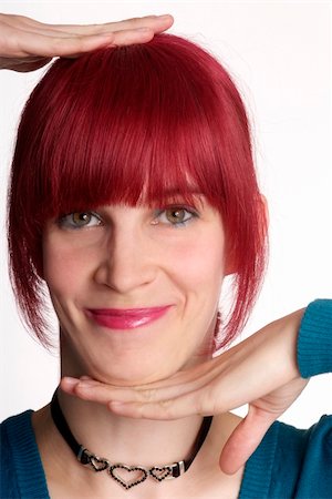 simsearch:400-04520503,k - a young woman with red hair and smile holds head Stock Photo - Budget Royalty-Free & Subscription, Code: 400-04013076