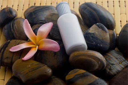 Aromatherapy and spa massage on tropical bamboo and polished stones. Stockbilder - Microstock & Abonnement, Bildnummer: 400-04013590