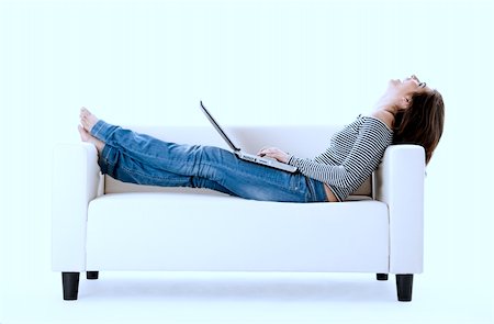 simsearch:400-04540351,k - Beautiful woman on a white sofa with a laptop Stock Photo - Budget Royalty-Free & Subscription, Code: 400-04013798