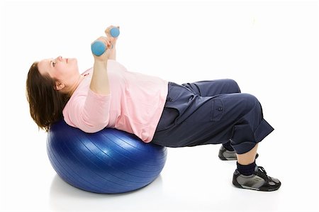 Beautiful plus sized model working out with free weights and a pilates ball.  Isolated on white. Stock Photo - Budget Royalty-Free & Subscription, Code: 400-04024299