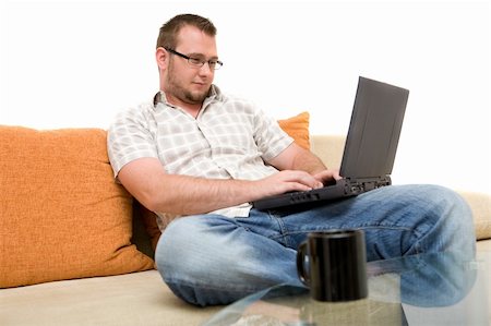 simsearch:400-05013654,k - happy man on sofa with laptop Photographie de stock - Aubaine LD & Abonnement, Code: 400-04024362