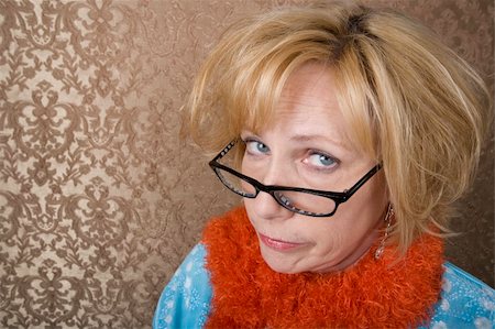 Crazy woman with glasses suspiciouly eyeing the camera Stock Photo - Budget Royalty-Free & Subscription, Code: 400-04024496