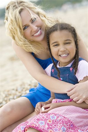 A beautiful blond haired blue eyed young woman having fun with her mixed race young daughter at the beach Stock Photo - Budget Royalty-Free & Subscription, Code: 400-04025100