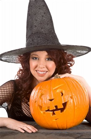 simsearch:400-04007612,k - Portrait of Hispanic teenager girl in black Halloween hat and fishnet dress by stone fence with carved pumpkin (Jack O' Lantern) (focous on pumpkin) Stock Photo - Budget Royalty-Free & Subscription, Code: 400-04025161
