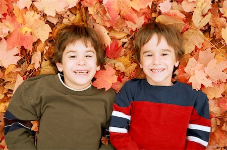 simsearch:400-05875962,k - Two Boys Laying Down in the Fall Leaves Photographie de stock - Aubaine LD & Abonnement, Code: 400-04025535