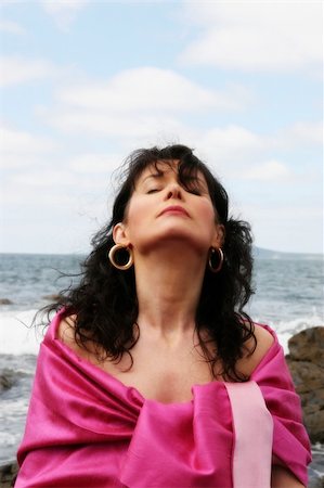 fitness   mature woman - beautiful woman meditating on the rocks in ireland with her eyes closed, in the lotus position, showing a healthy way to live a happy and relaxed lifestyle in a world full of stress Stock Photo - Budget Royalty-Free & Subscription, Code: 400-04025890