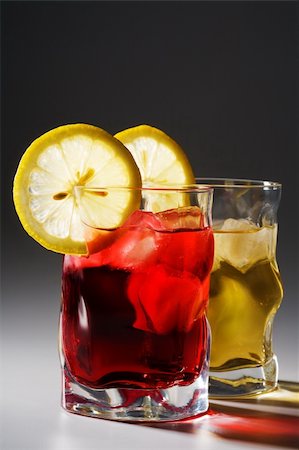 simsearch:400-03979160,k - Beautiful glasses with a cocktail, a lemon and an ice Stock Photo - Budget Royalty-Free & Subscription, Code: 400-04025926