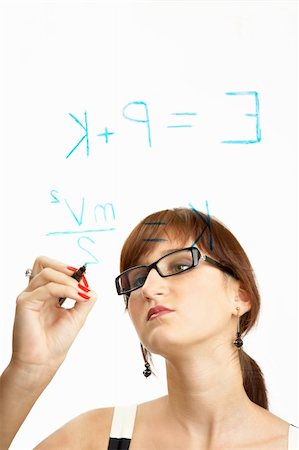 The young scientific girl in glasses with concentration writes formulas on glass Stock Photo - Budget Royalty-Free & Subscription, Code: 400-04026001