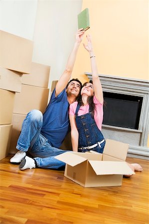 simsearch:614-03648212,k - Young couple being silly with moving boxes at home Stock Photo - Budget Royalty-Free & Subscription, Code: 400-04026113