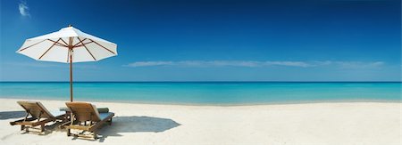 Panoramic view of two chairs and white umbrella on the beach. Banner, lots of copy space Stock Photo - Budget Royalty-Free & Subscription, Code: 400-04026254