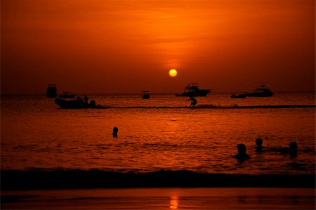 Swimmers and water skier in the Pacific Ocean at sunset Stock Photo - Budget Royalty-Free & Subscription, Code: 400-04026278
