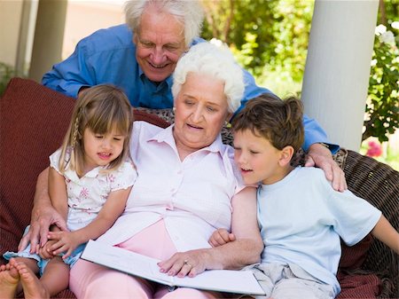 Grandparents reading to grandchildren Stock Photo - Budget Royalty-Free & Subscription, Code: 400-04026599