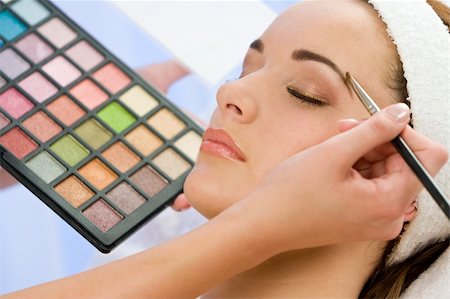 A beautiful young woman having the final touches applied to her make up by a beautician Stock Photo - Budget Royalty-Free & Subscription, Code: 400-04026804