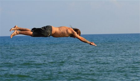 sergey02 (artist) - Man jumping into the sea Stockbilder - Microstock & Abonnement, Bildnummer: 400-04027654
