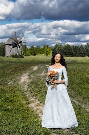 Beautiful smiling girl with a bouquet of roses and old mill Stock Photo - Budget Royalty-Free & Subscription, Code: 400-04027784