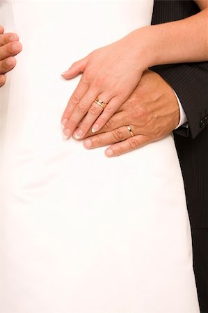 simsearch:400-05161652,k - Bride and bridegroom hands over wedding dress (wedding rings) Photographie de stock - Aubaine LD & Abonnement, Code: 400-04028137