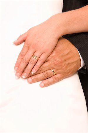 simsearch:400-03932395,k - Bride and bridegroom hands over wedding dress (wedding rings) Fotografie stock - Microstock e Abbonamento, Codice: 400-04028138