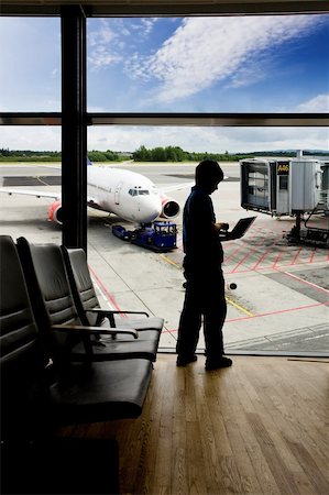 plane delay - A young man using a laptop in an airport terminal Stock Photo - Budget Royalty-Free & Subscription, Code: 400-04028224