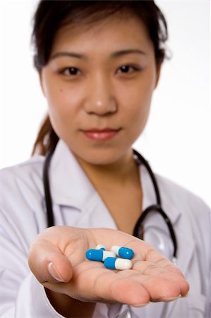 racnus (artist) - Female doctor handing pill in white background. Fotografie stock - Microstock e Abbonamento, Codice: 400-04020078