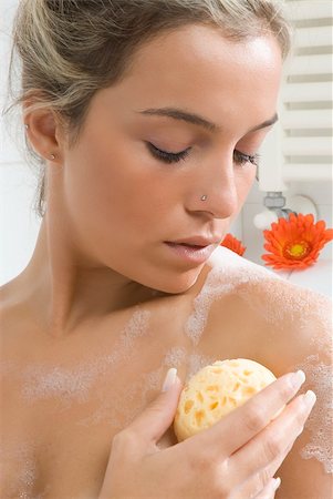 sponge bath woman - close up of a nice blond taking off foam from her body with sponge Stock Photo - Budget Royalty-Free & Subscription, Code: 400-04020402