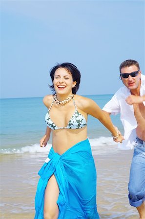 simsearch:400-05227851,k - a portrait of attractive couple having fun on the beach Fotografie stock - Microstock e Abbonamento, Codice: 400-04021212