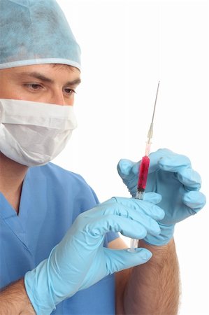 Doctor, surgeon, hematologist or other medical specialist checking or preparing a syringe needle.  Focus to hands and syringe. Photographie de stock - Aubaine LD & Abonnement, Code: 400-04021448