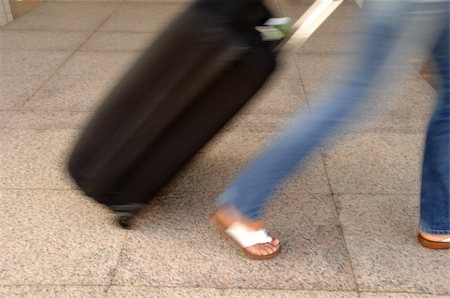 simsearch:400-07262064,k - Woman and suitcase. Note that the picture is in motion blur. Stock Photo - Budget Royalty-Free & Subscription, Code: 400-04021473