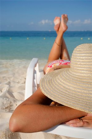 simsearch:400-04018254,k - Woman sunbathing on a sun lounger on a tropical beach Stockbilder - Microstock & Abonnement, Bildnummer: 400-04021632