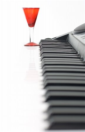 piano class - Piano keyboard and red glass on isolated background Stock Photo - Budget Royalty-Free & Subscription, Code: 400-04021717