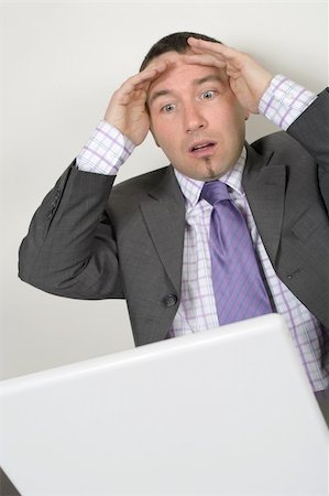 simsearch:400-05209351,k - Horrified businessman in his thirties looking at a bad thing on his laptop. Stock Photo - Budget Royalty-Free & Subscription, Code: 400-04021718