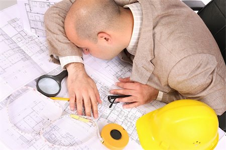 A businessman sleepy with architectural plans at desk Stock Photo - Budget Royalty-Free & Subscription, Code: 400-04021770