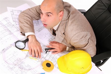 A businessman sleepy with architectural plans at desk Stock Photo - Budget Royalty-Free & Subscription, Code: 400-04021773