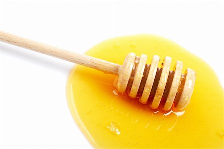 simsearch:400-04865454,k - Honey and wooden drizzler reflected on white background. Shallow DOF Stockbilder - Microstock & Abonnement, Bildnummer: 400-04021916