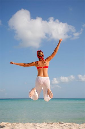 simsearch:400-04215852,k - Woman in red and white jumping on the beach Stock Photo - Budget Royalty-Free & Subscription, Code: 400-04022104