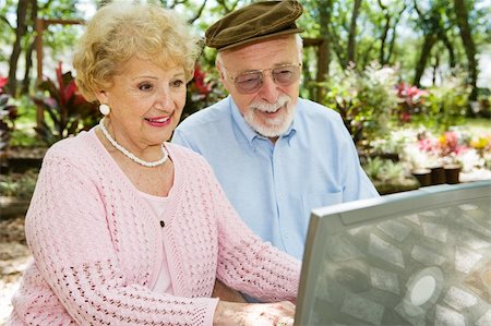 simsearch:400-04065020,k - Happy senior couple on their laptop computer in a beautiful outdoor setting. Foto de stock - Royalty-Free Super Valor e Assinatura, Número: 400-04022100