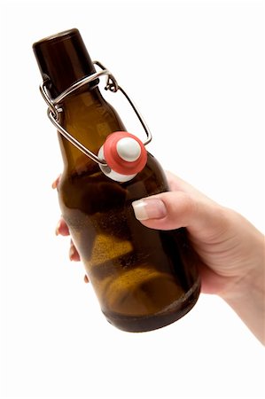 Female hand holding an opened beer bottle. Isolated on a white background. Stock Photo - Budget Royalty-Free & Subscription, Code: 400-04022832