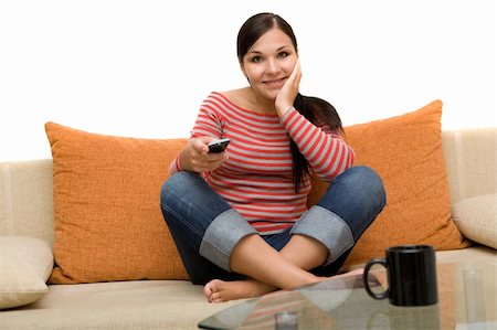 simsearch:400-05195435,k - attractive brunette woman on sofa with remote control Stockbilder - Microstock & Abonnement, Bildnummer: 400-04023475