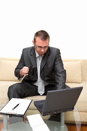 simsearch:400-05013654,k - happy man sitting on sofa with laptop Photographie de stock - Aubaine LD & Abonnement, Code: 400-04023476