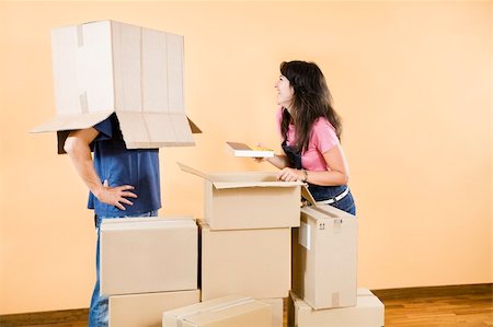 simsearch:614-03648212,k - Young couple being silly with moving boxes at home Stock Photo - Budget Royalty-Free & Subscription, Code: 400-04023689