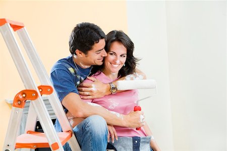 simsearch:400-04023689,k - Young Hispanic couple playing with paint in new home Foto de stock - Super Valor sin royalties y Suscripción, Código: 400-04023694