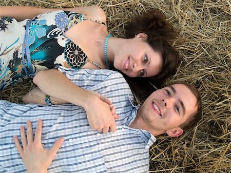 Lovely young couple lying in stray in filed Stock Photo - Budget Royalty-Free & Subscription, Code: 400-04023696