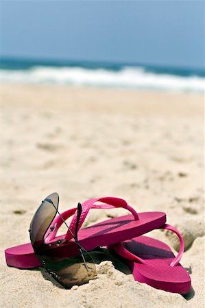 pink flip flops beach - Sunglasses and pink flip flops in the sand Stock Photo - Budget Royalty-Free & Subscription, Code: 400-04023716