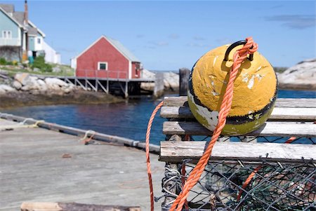simsearch:400-05677109,k - A view of Peggy's Cove in Nova Scotia, Canada with a lobster trap and float marking the foreground. Stock Photo - Budget Royalty-Free & Subscription, Code: 400-04023743
