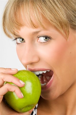 portrait photo teenage girl long blonde hair'''' - close up of a nice blond woman eating a green apple Stock Photo - Budget Royalty-Free & Subscription, Code: 400-04023802