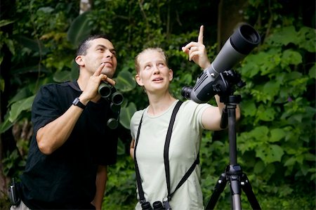 simsearch:400-04729405,k - Pretty Woman with Binoculars and Man with Telescope in Rain Forest Jungle Photographie de stock - Aubaine LD & Abonnement, Code: 400-04023831