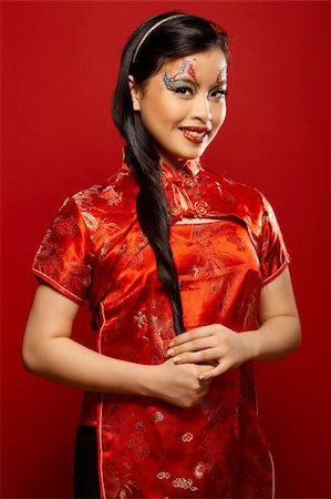 simsearch:400-04780842,k - Beautiful Asian girl as a plastic doll on red background Stock Photo - Budget Royalty-Free & Subscription, Code: 400-04034311