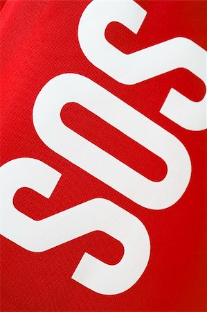 SOS ("save our souls") lettering on a red fabric first aid kit Stock Photo - Budget Royalty-Free & Subscription, Code: 400-04034897